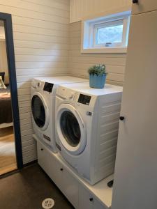 a laundry room with a washer and dryer at Nátthagi Luxury Cottage in Snæfellsbær