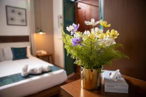 Postel nebo postele na pokoji v ubytování Sweet Cili Boutique Hotel