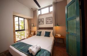Postel nebo postele na pokoji v ubytování Sweet Cili Boutique Hotel