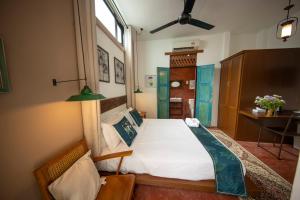 Postel nebo postele na pokoji v ubytování Sweet Cili Boutique Hotel