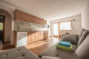 a living room with a couch and a kitchen at Residencesora in San Vigilio Di Marebbe +16 photos