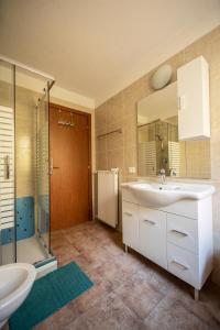 a bathroom with a sink and a shower and a mirror at Residencesora in San Vigilio Di Marebbe