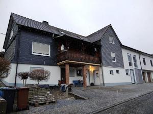 a house with a black and white house at Ferienwohnung Schuppener in Puderbach