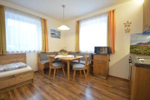 a kitchen and dining room with a table and chairs at Appartement Jäger Manuela in Flachau