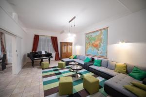 a living room with a couch and a piano at Ferienwohnung Mariazell - Hulatsch in Mariazell