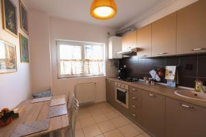 a kitchen with a table and a sink in it at Zorilor View Apartment in Cluj-Napoca