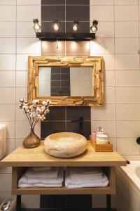 a bathroom with a mirror and a table with towels at Zorilor View Apartment in Cluj-Napoca +9 photos