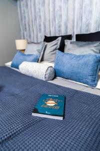 a book sitting on top of a bed at Zorilor View Apartment in Cluj-Napoca