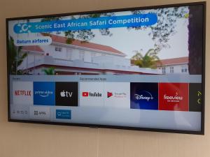 a flat screen tv hanging on a wall at Kerikeri Homestead Motel & Apartments in Kerikeri