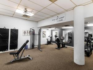 einen Fitnessraum mit Laufbändern und Kardiogeräten in einem Zimmer in der Unterkunft Paradise Inn & Conference Centre in Grande Prairie