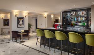 a bar with green bar stools in a restaurant at Edmond Rosh Pina in Rosh Pinna