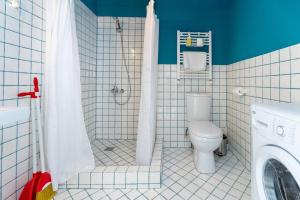a bathroom with a shower with a toilet and a sink at Wehost Apartment With Huge Terrace in Tbilisi City