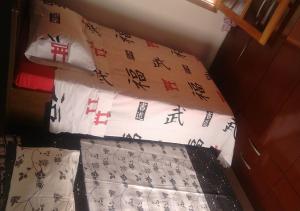 a bed with two pillows with asian writing on it at Chalé Boa Vista in São Thomé das Letras
