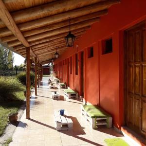 a row of benches sitting on the side of a building at Complejo Los Parrales in General Alvear