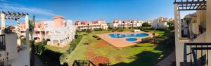 arial view of a large apartment complex with a swimming pool at Appartement El Bahia Saidia destiné uniquement aux couple mariés, célibataires s'abstenir in Saïdia