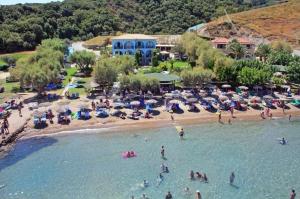a group of people in the water at a beach at Fiore Beach Studios in Vasilikos
