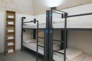 Postel nebo postele na pokoji v ubytování Ostello dei Sassi - Matera Hostels