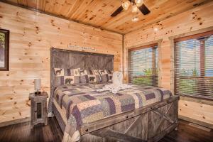 a bedroom with a bed in a log cabin at Rainwater Falls in Gatlinburg +57 photos