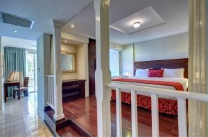 a hotel room with a bed and a balcony at Mystique St Lucia by Royalton in Gros Islet