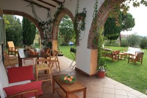 a patio with an archway and tables and chairs at Vigna Luisa Resort - Near Rome in Genzano di Roma