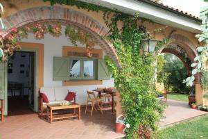 an outdoor patio with an arch with a table and chairs at Vigna Luisa Resort - Near Rome in Genzano di Roma
