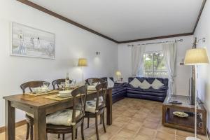 comedor con mesa, sillas y sofá en Seaview Terrace Benagil Villa 45, en Benagil