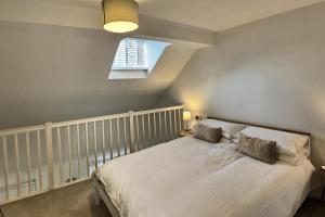 a bedroom with a large white bed with a window at 52 Minster in Beverley