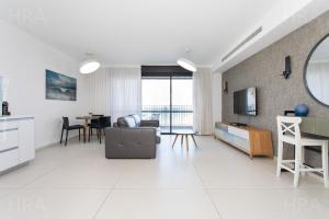 a white living room with a couch and a table at Bat Galim Luxury balcony SEA view Nearby The Beach for Doctor's in Haifa