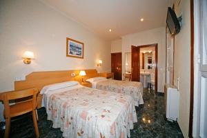 Postel nebo postele na pokoji v ubytování Hostal Prim