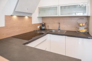 a kitchen with a sink and a vase on the counter at MH Living - 11 - Modern Living Dream in Center in Graz