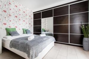 a bedroom with a bed and a dresser at Grand Budapest Apartments in Budapest
