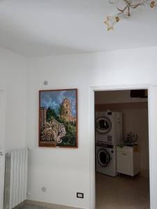 a painting hanging on a wall in a room at Casa Mavì Limite delle due Matrici in Modica