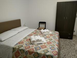 a bedroom with a bed with towels on it at Casa Mavì Limite delle due Matrici in Modica