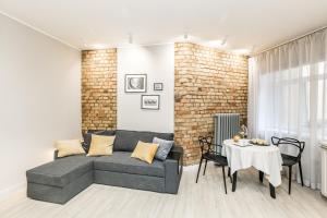 a living room with a couch and a table at Cozy flat. Art Nouveau building, near the city center in Rīga