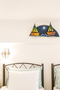 a shelf above a bed with two boats on it at Alexandros Hotel Apartments in Vourvourou
