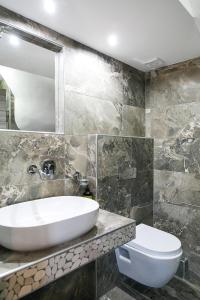 a bathroom with a sink and a toilet at Alexandros Hotel Apartments in Vourvourou