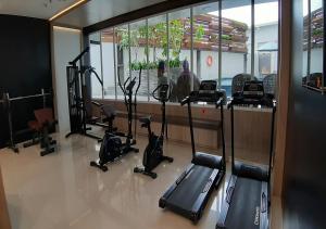 a gym with treadmills and exercise bikes in a room at Apartemen Taman Melati Yogyakarta by ArFe Room in Sleman
