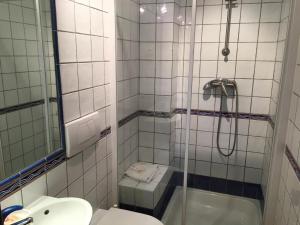 a bathroom with a shower and a toilet and a sink at Seaview Terrace Benagil Villa 45 in Benagil +21 photos