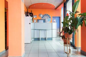 a corridor of a restaurant with orange walls at Hotel Beta in Cluj-Napoca