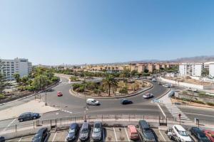 a street with cars parked in a parking lot at Residence Los Molinos in Maspalomas
