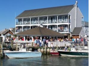 a large building with boats docked at a dock with people at Talbot Inn in Ocean City