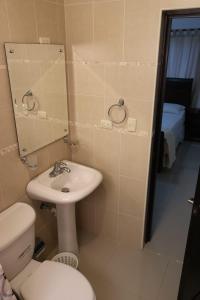 a bathroom with a sink and a toilet and a mirror at Tu Segundo Hogar en Santiago, La Cuidad CORAZÓN in Santiago de los Caballeros +58 photos