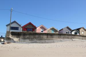 a row of houses on the beach next to the beach at Casa do Mar in Vila Chã +21 photos