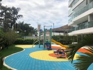 a playground with a slide in a building at San Sebastian Riviera pé na areia in Riviera de São Lourenço