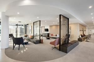 a lobby with couches and chairs in a building at Quest Goulburn in Goulburn