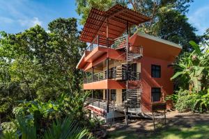 un edificio con una escalera en medio de árboles en Jungle Lodge at Wild Sun Rescue Center, en Cabuya