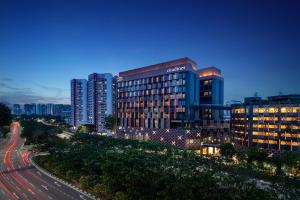 a view of a city at night with buildings at Citadines Rochor in Singapore