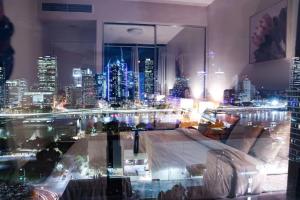 a room with a view of a city at night at Lucid Apartment South Brisbane in Brisbane