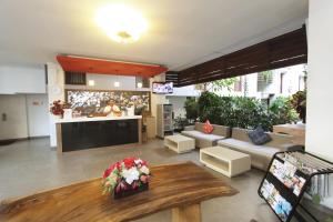 a living room with a couch and a table at The Legian Sunset Residence in Seminyak