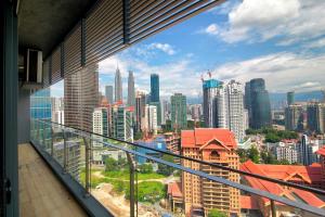 a view of a city skyline from a balcony at Vale Pine Dorsett Residences Bukit Bintang in Kuala Lumpur